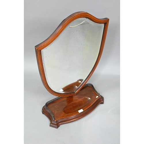 876 - A large Victorian Sheraton Revival mahogany framed adjustable shield shaped toilet mirror, with beve... 