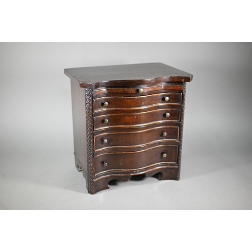 877 - An miniature mahogany serpentine chest of four long graduated drawers, in the Chippendale style with... 