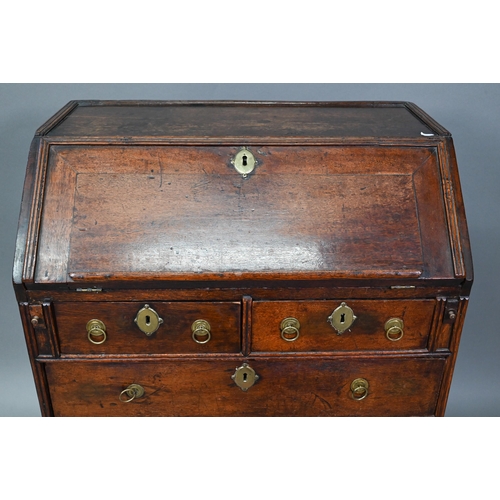 884 - A mid 18th oak bureau of diminutive proportions, the interior with basic drawers and niches over fou... 