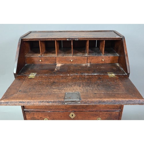 884 - A mid 18th oak bureau of diminutive proportions, the interior with basic drawers and niches over fou... 