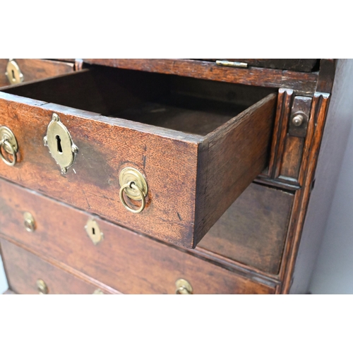 884 - A mid 18th oak bureau of diminutive proportions, the interior with basic drawers and niches over fou... 