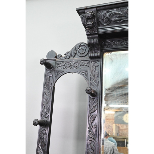 887 - A Victorian carved oak mirror backed hall stand, with cupboard and twin stick stands, 119 cm w x 39 ... 