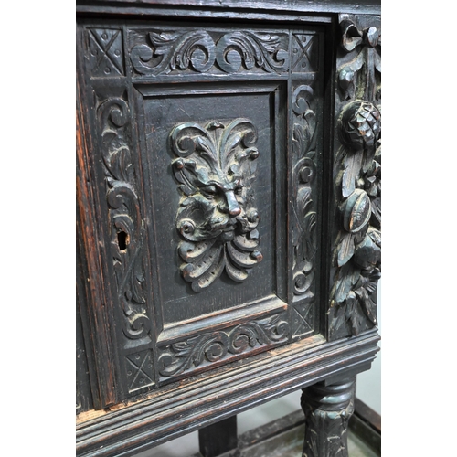 887 - A Victorian carved oak mirror backed hall stand, with cupboard and twin stick stands, 119 cm w x 39 ... 