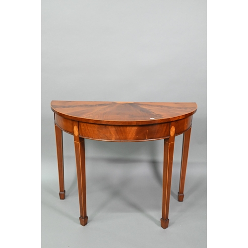 888 - A pair of boxwood inlaid figured mahogany Sheraton Revival demi-lune tables, raised on square taperi... 