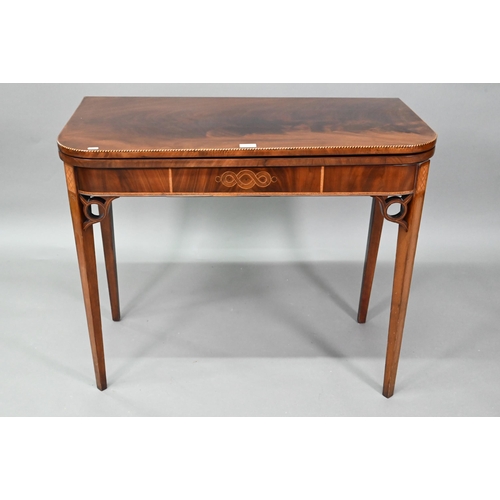 889 - A Victorian figured mahogany inlaid tea table, the fold over top raised on canted square tapering le... 