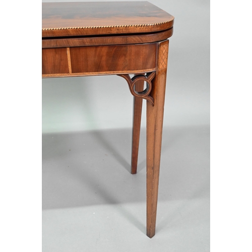 889 - A Victorian figured mahogany inlaid tea table, the fold over top raised on canted square tapering le... 