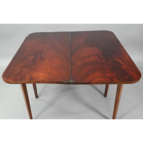 889 - A Victorian figured mahogany inlaid tea table, the fold over top raised on canted square tapering le... 