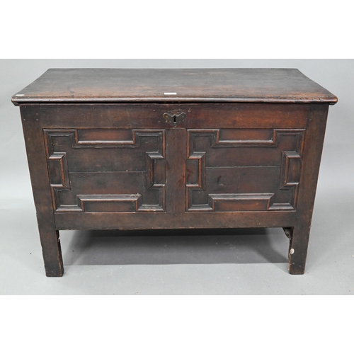 902 - A late 17th century oak coffer, with applied geometric moulded front panels, raised on stiles - prev... 