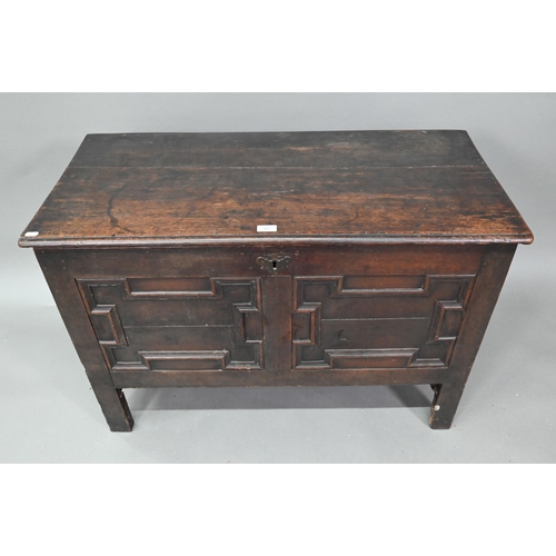 902 - A late 17th century oak coffer, with applied geometric moulded front panels, raised on stiles - prev... 