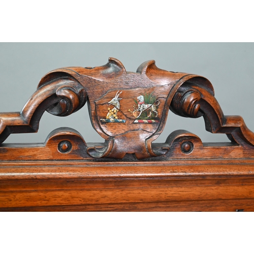 905 - A Victorian mahogany framed fire screen with polychrome armorial device to the crest rail, over a fa... 