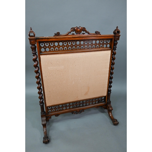 905 - A Victorian mahogany framed fire screen with polychrome armorial device to the crest rail, over a fa... 