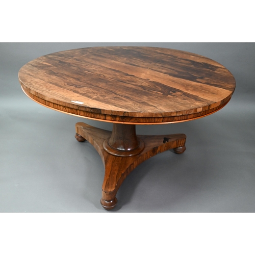 909 - An early Victorian rosewood breakfast table, the circular tilt top raised on a turned support, to a ... 