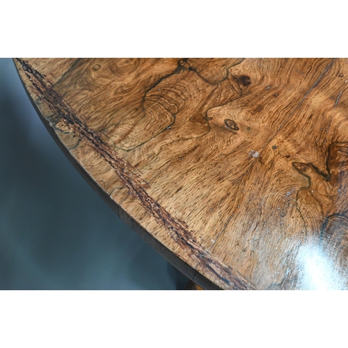 909 - An early Victorian rosewood breakfast table, the circular tilt top raised on a turned support, to a ... 