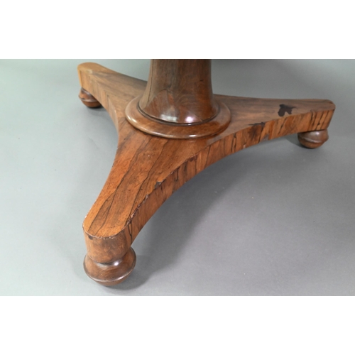 909 - An early Victorian rosewood breakfast table, the circular tilt top raised on a turned support, to a ... 