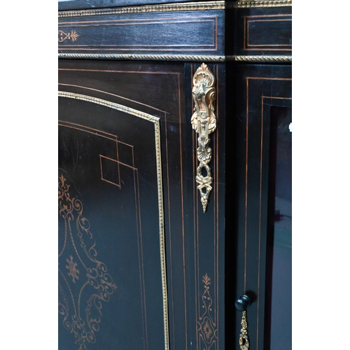 918 - A Victorian gilt metal mounted ebonised credenza, the gilt stencilled centre cabinet door flanked by... 