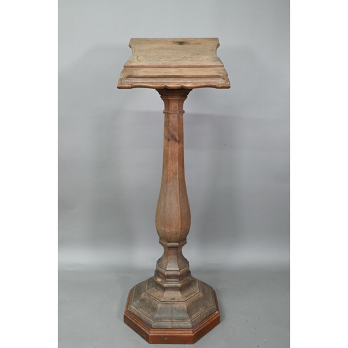 921 - A weathered antique oak lectern, the sloped shaped top raised on octagonal baluster column and stepp... 