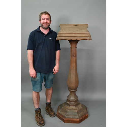 921 - A weathered antique oak lectern, the sloped shaped top raised on octagonal baluster column and stepp... 