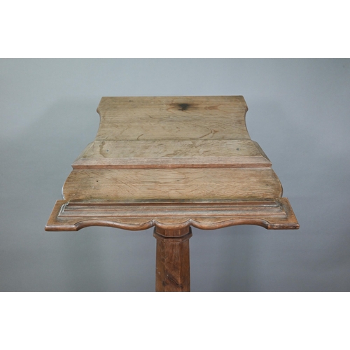 921 - A weathered antique oak lectern, the sloped shaped top raised on octagonal baluster column and stepp... 