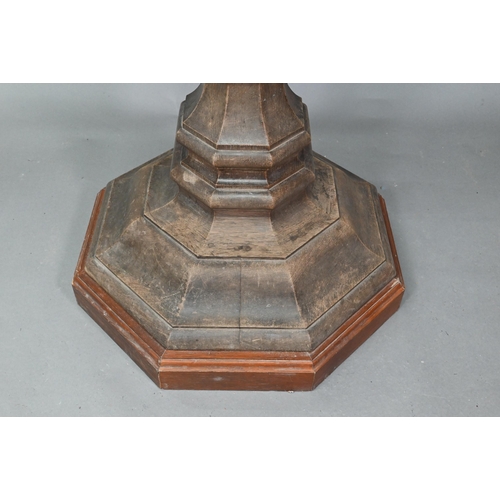 921 - A weathered antique oak lectern, the sloped shaped top raised on octagonal baluster column and stepp... 