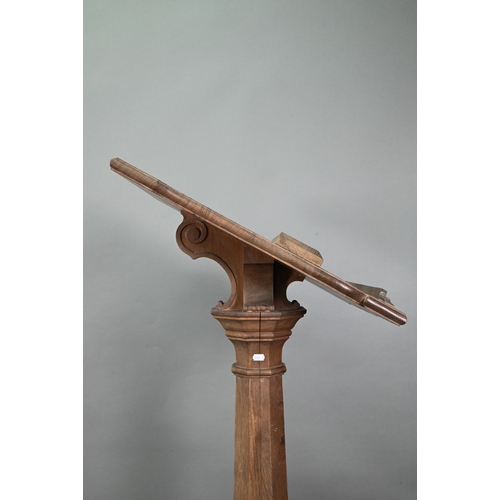 921 - A weathered antique oak lectern, the sloped shaped top raised on octagonal baluster column and stepp... 