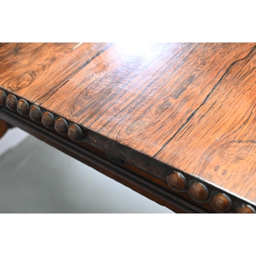 922 - A Regency rosewood sofa/library table, the rectangular top with beaded edge and rounded drop leaf en... 