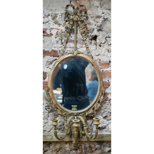 926 - A Georgian oval giltwood girandole mirror with triple scroll arms from an Adan style urn, suspended ... 