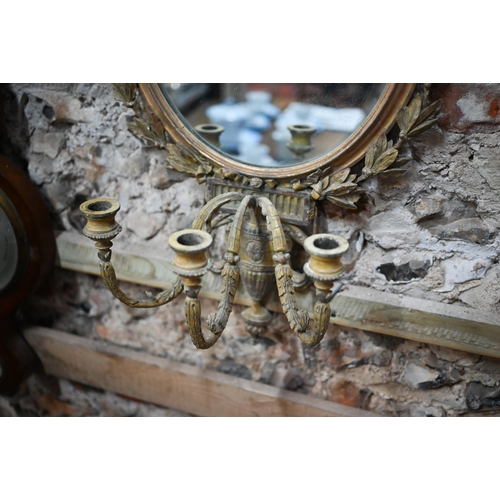 926 - A Georgian oval giltwood girandole mirror with triple scroll arms from an Adan style urn, suspended ... 