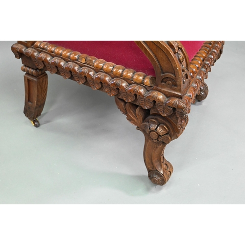 928 - A carved and moulded oak framed 'throne' chair, with crimson fabric panelled back and seat, the vers... 