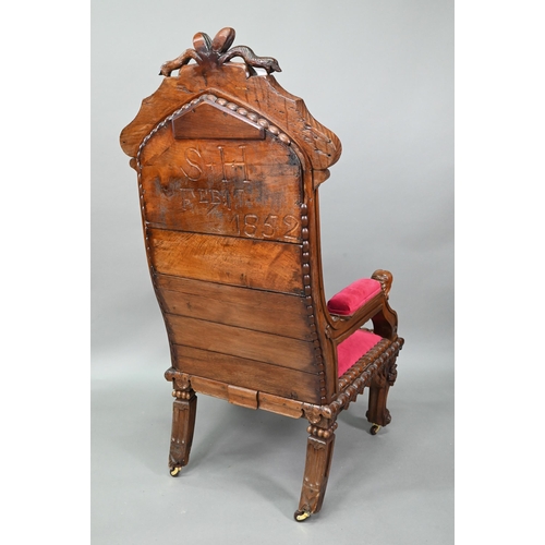 928 - A carved and moulded oak framed 'throne' chair, with crimson fabric panelled back and seat, the vers... 