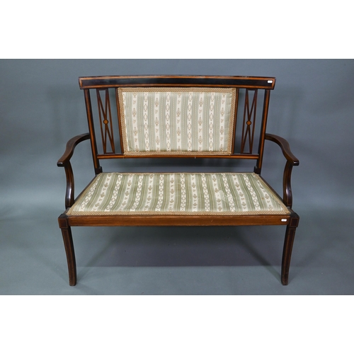 931 - An Edwardian Sheraton Revival satinwood framed sofa, with fabric back panel and seat, raised on shap... 