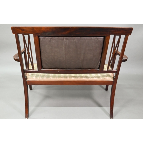 931 - An Edwardian Sheraton Revival satinwood framed sofa, with fabric back panel and seat, raised on shap... 