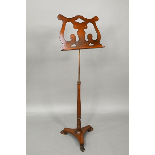 933 - A Victorian mahogany single music stand, with brass rise and fall pole on a tri-form platform base o... 