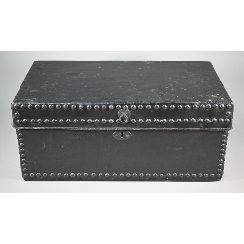 938 - An antique studded black clad leather trunk, with carrying handle to each side, 57 cm x 30cm x 26 cm... 