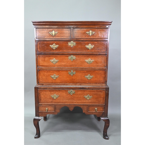 939 - A George II oak chest on stand comprised of two short over three long graduated drawers, over a furt... 