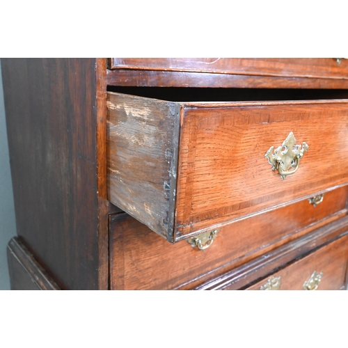 939 - A George II oak chest on stand comprised of two short over three long graduated drawers, over a furt... 