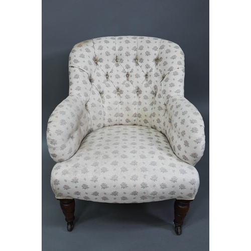 942 - A Victorian button backed armchair, raised on turned front legs on ceramic castors, 85 cm high, 73 c... 