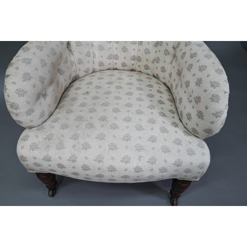 942 - A Victorian button backed armchair, raised on turned front legs on ceramic castors, 85 cm high, 73 c... 