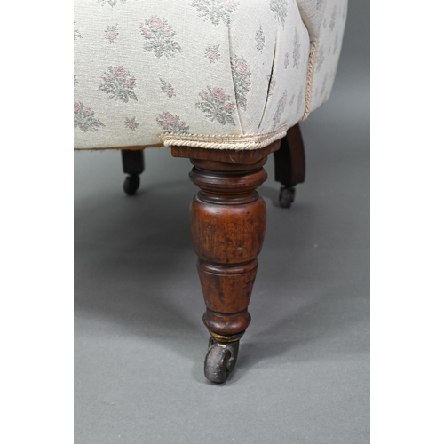 942 - A Victorian button backed armchair, raised on turned front legs on ceramic castors, 85 cm high, 73 c... 