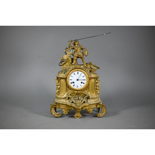 943 - A 19th century ormolu 8-day mantel clock, surmounted by a spear wielding warrior with white enamelle... 