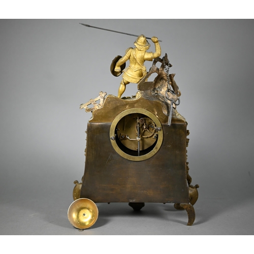 943 - A 19th century ormolu 8-day mantel clock, surmounted by a spear wielding warrior with white enamelle... 