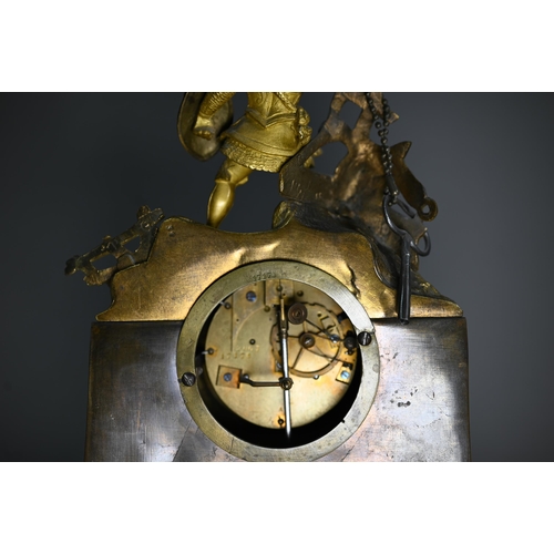 943 - A 19th century ormolu 8-day mantel clock, surmounted by a spear wielding warrior with white enamelle... 