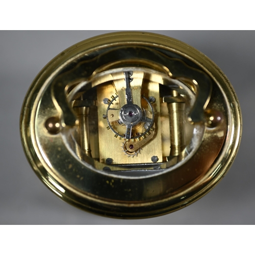 961 - A lacquered brass oval cased carriage clock, the 8-day movement with white enamelled dial, 9 cm h