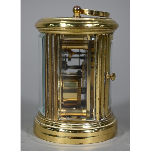 961 - A lacquered brass oval cased carriage clock, the 8-day movement with white enamelled dial, 9 cm h