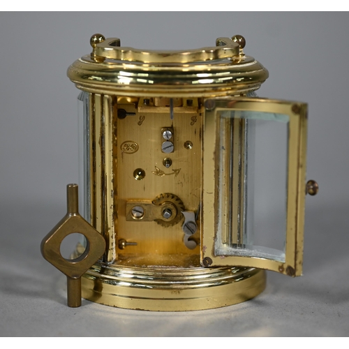 961 - A lacquered brass oval cased carriage clock, the 8-day movement with white enamelled dial, 9 cm h