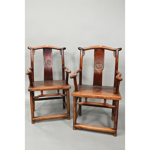 965 - A pair of Chinese elm 'official's hat' wedding chairs in the Ming dynasty manner, the shaped backres... 