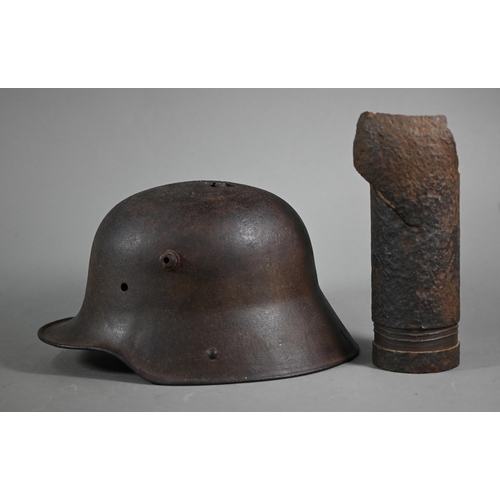 1059 - A WWI German helmet 'Delville Wood' to/with a Somme shell fragment - both heavily degraded battlefie... 
