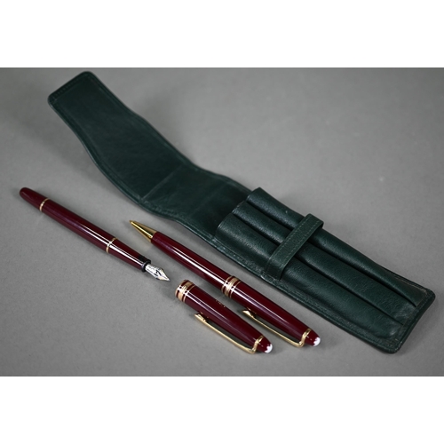 1115 - A Montblanc Meisterstuck fountain pen and ballpoint pen set, with gilt-mounted maroon bodies, the fo... 