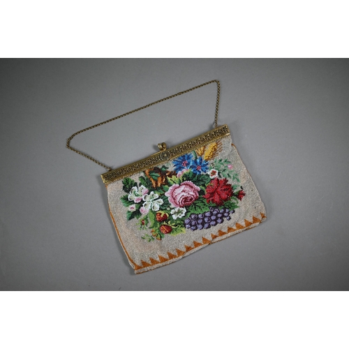 1121 - A glass beadwork bag decorated with flowers, circa 1900, on gilt metal folding clasp fitting, and ch... 