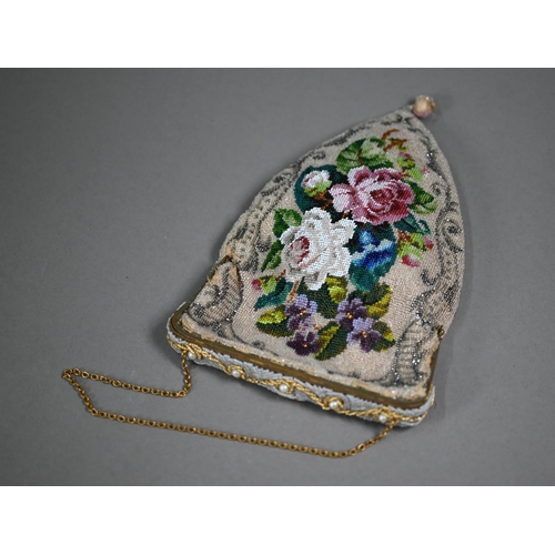 1122 - A circa 1900 ladies beadwork bag of shaped form, the glass bead and cut steel decoration depicting f... 