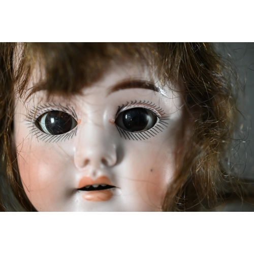 1196 - An early 20th century German Ernst Heubach china-headed girl doll with brown wig, sleeping brown eye... 